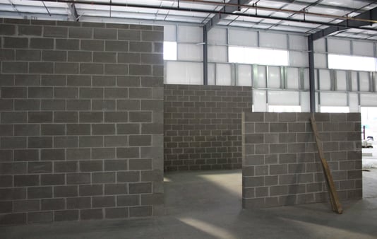 Cement brick walls for an office buildout in a manufacturing facility