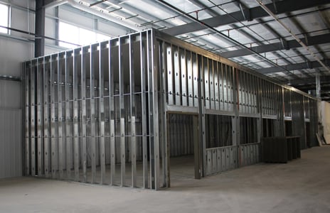 Steel wall structure for an office buildout in a manufacturing facility